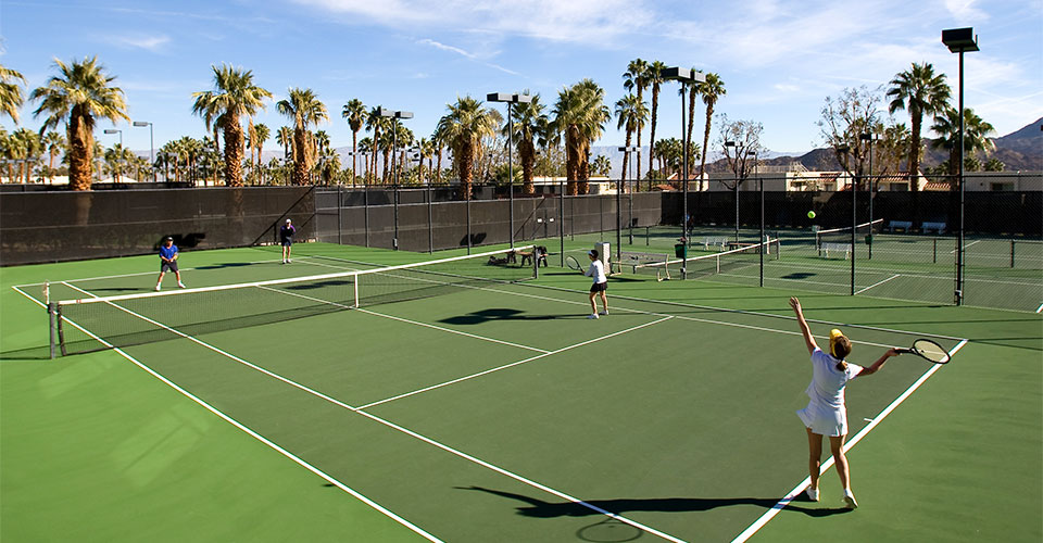 Group of friends playing a round of tennis